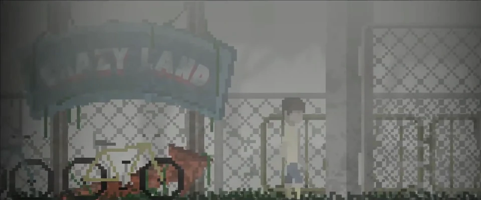 William stands at the fog-shrouded gates of the abandoned Crazy Land fairground, bicycles parked beneath its faded sign